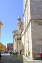 April 2022 Modena, Italy: Tower Ghirlandina and the Duomo Modena on the square piazza della Torre on a sunny day full of visitors