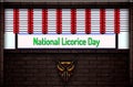 April month special day. National Licorice Day, Neon Text Effect on Bricks Background