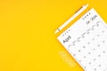 April 2024, Monthly desk calendar for 2024 year and pen with paper clips on yellow color background Royalty Free Stock Photo