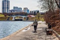 19 April, 2018 -Moscow city Park. Happy elderly woman engaged in Nordic walking in nature.