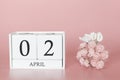 April 02nd. Day 2 of month. Calendar cube on modern pink background, concept of bussines and an importent event