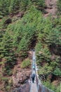 8 April 2018 - Nepal ::trekker cross the river by suspension bridge Royalty Free Stock Photo