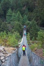 8 April 2018 - Nepal ::trekker cross the river by suspension bridge Royalty Free Stock Photo