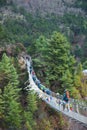 8 April 2018 - Nepal ::trekker cross the river by suspension bridge Royalty Free Stock Photo