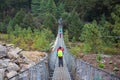 8 April 2018 - Nepal ::trekker cross the river by suspension bridge Royalty Free Stock Photo