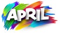 April paper word sign with colorful spectrum paint brush strokes over white