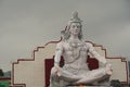 Hindu god Shiva sculpture sitting in meditation on Ganges river in Rishikesh, India