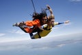 An instructor with dreadlocks and a female student jump tandem
