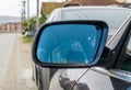 April 06. 2021: Rear-view mirror of a parked vehicle on the outskirts of the city. Royalty Free Stock Photo