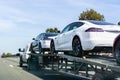 April 26, 2019 Redwood City / CA / USA - Car transporter carries Tesla Model 3 new vehicles along a highway in San Francisco bay Royalty Free Stock Photo