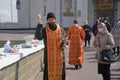 April 19, 2020, Russia, Magnitogorsk. Church Easter rite of blessing food during the coronavirus pandemic. The priest sprinkles Royalty Free Stock Photo