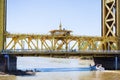 April 14, 2018 Sacramento / CA / USA - People sightseeing on the Tower Bridge; boat passing underneath it