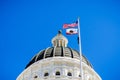 April 14, 2018 Sacramento / CA / USA - The US and the California state flag waving in the wind in front of the dome of the Royalty Free Stock Photo