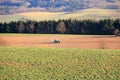 April 7 2018 - Saxony, Germany: a Tractor working on the farm, a modern agricultural transport, a farmer working in the field, Royalty Free Stock Photo