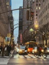 April 2022: Street scene in New York at dusk with traffic, buildings and people