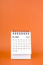 April 2024 table calendar on orange color background