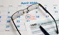 April 15 tax day calendar glasses and declaration on the table