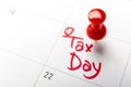 April tax day written and pinned in a calender, close up Royalty Free Stock Photo