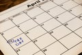 April tax day written and pinned in a calender, close up. Toned. Royalty Free Stock Photo