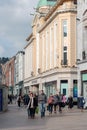 People shopping on Patrick Street in Cork, the city`s main street for stores, street performers, restaurants, and busy city life.