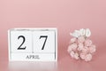 April 27th. Day 27 of month. Calendar cube on modern pink background, concept of bussines and an importent event