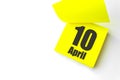 April 10th. Day 10 of month, Calendar date. Close-Up Blank Yellow paper reminder sticky note on White Background. Spring month, Royalty Free Stock Photo