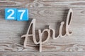 April 27th. Day 27 of month, daily calendar on wooden table background. Spring time theme