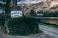 Gougane Barra Hotel sign with the Saint Finbarr`s Oratory chapel and the lake in the background.