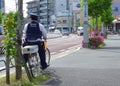 2017 April 05. TOKYO JAPAN. A policeman on bicycle looking for the safety of population in EDOKAWA city