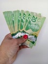 April 10 2024 Toronto Ontario Canada Canadian twenty dollar bills in a brown persons hand Royalty Free Stock Photo