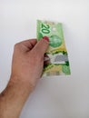 April 10 2024 Toronto Ontario Canada Canadian twenty dollar bill in a brown persons hand Royalty Free Stock Photo