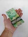 April 10 2024 Toronto Ontario Canada Canadian twenty dollar bills in a brown persons hand Royalty Free Stock Photo