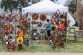 April 13 2018 Tulsa USA Tent booth at spring garden fair with all kinds of brightly colored yard ornaments on display and woman