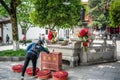 Chinese Woman offering money to a goddess statue at Guiyuan Buddhist temple in Wuhan Hubei China