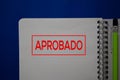 Aprobado write on a book spanish language isolated on blue background Royalty Free Stock Photo