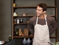 Apron, smile and handsome man ready to cook at restaurant or a kitchen. Retail, male shopkeeper and prepare meal at cafe
