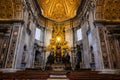 The Apse of Saint Peter`s Basilica Close Up with the golden light of a morning sun lighting up the stain glass window illuminating Royalty Free Stock Photo