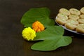 Apta leaf with Marigold flowers and sweet, a concept for Dussehara or Vijayadashami, an Indian festival