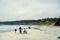 People relaxing and admiring the views on the beach along Monterey Bay, in Carmel by the Sea, California, United States