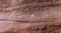 Fragment of surviving rock inscriptions left over from ancient times on a rock in the Wadi Rum desert near Aqaba city in Jordan