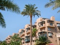 MÃÂ¶venpick Aqaba luxury hotel apartment building surrounded by palm trees Royalty Free Stock Photo