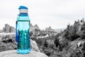 Aqua Blue Fitness Water Bottle with Mountains in Background