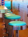 Aqua and chrome diner counter stools in row Royalty Free Stock Photo