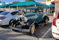 Aqua green Ford Model A in parking lot