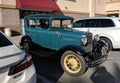 Aqua green Ford Model A in parking lot