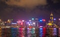 The Aqua Luna sailing in Hong Kong Downtown with skyscraper buildings. financial district in urban city at night. The red boat or