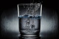 Super slow motion shot of water splashing from glass. Aqua water pouring in freshness purify concept with drops Royalty Free Stock Photo