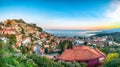 Aquamarine blue waters of  sea and fantastic cityscape of Taormina during sunset Royalty Free Stock Photo