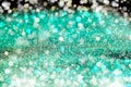 Aquamarine Sparkling Lights Festive background with texture. Abstract Christmas twinkled bright bokeh defocused and Falling stars. Royalty Free Stock Photo