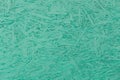 Aquamarine turquoise paint chipboard abstract pattern surface, pressed wood texture, particleboard background